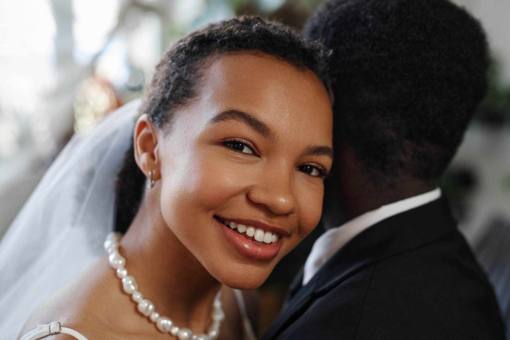 Joyful bride embracing her groom