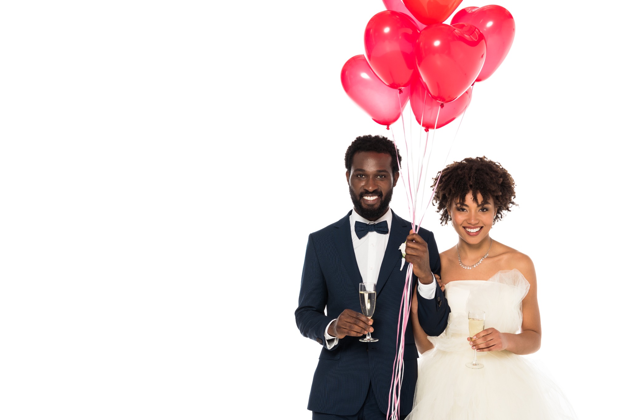 Newlyweds celebrating with champagne and heart balloons