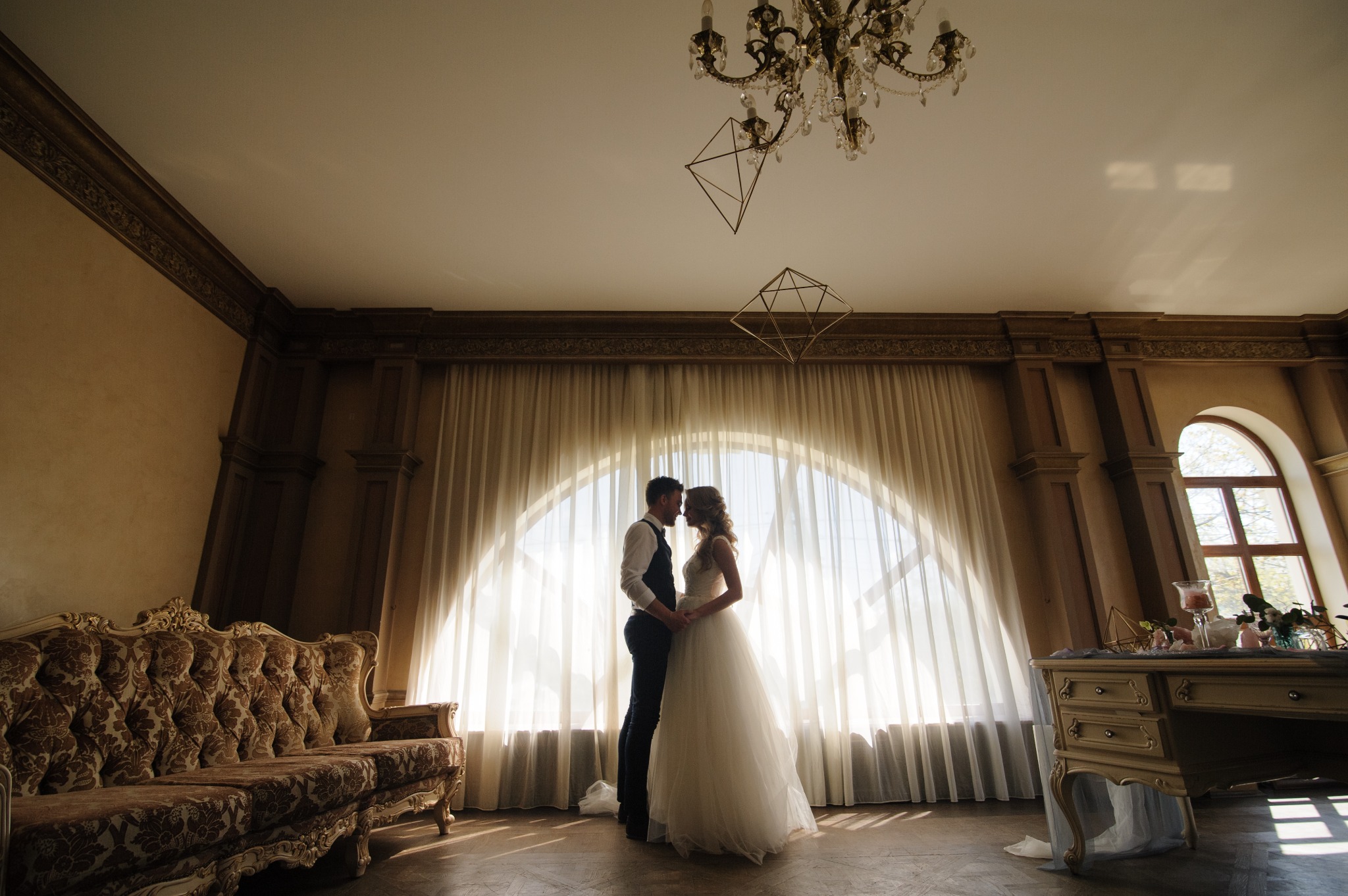 Elegant wedding couple embracing indoors
