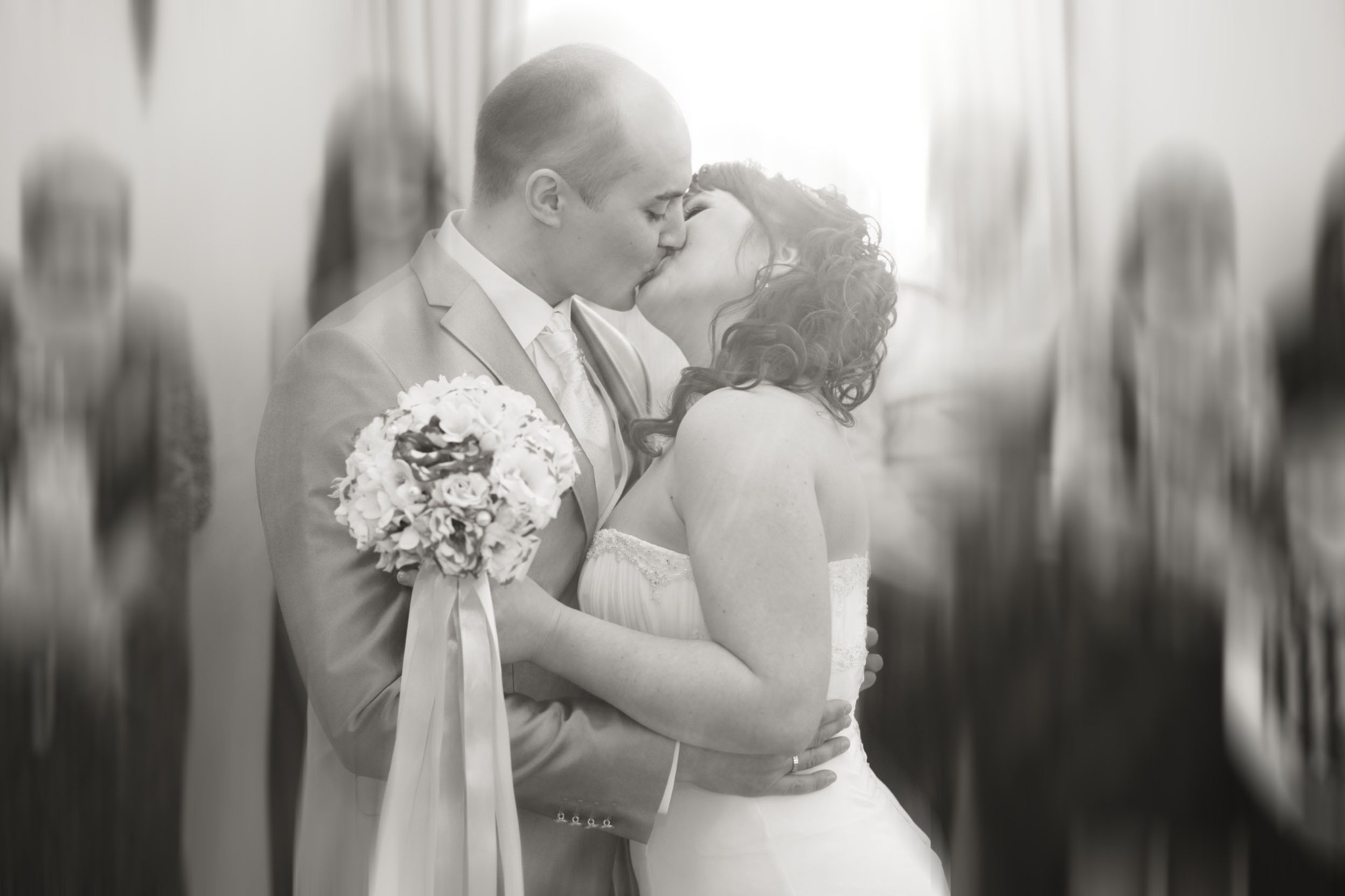 Wedding couple sharing a soft black-and-white embrace